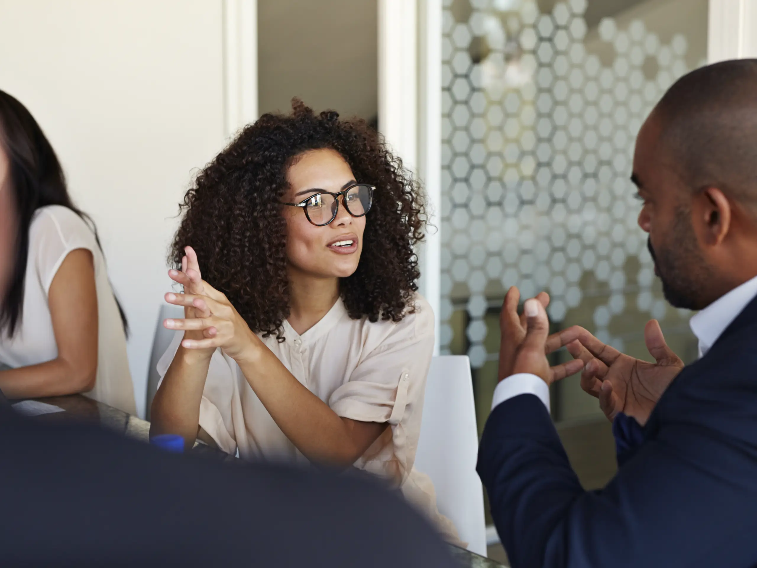 People discussing business topics during a meeting in an office