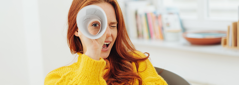 Woman looking through funnel