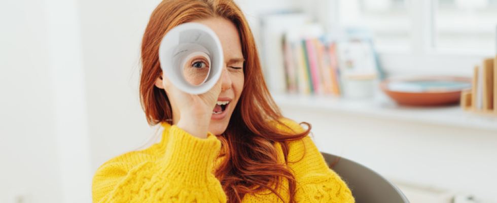 woman looking through funnel