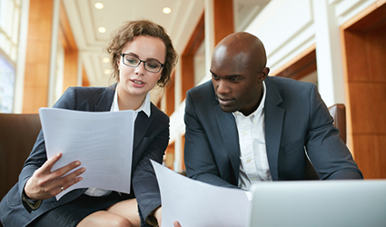 two people looking at paperwork