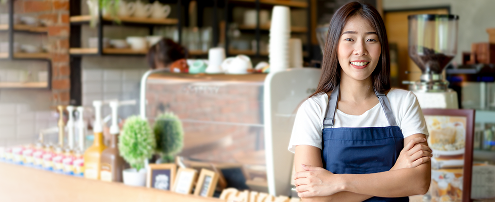 Woman standing in front of restaurant counter