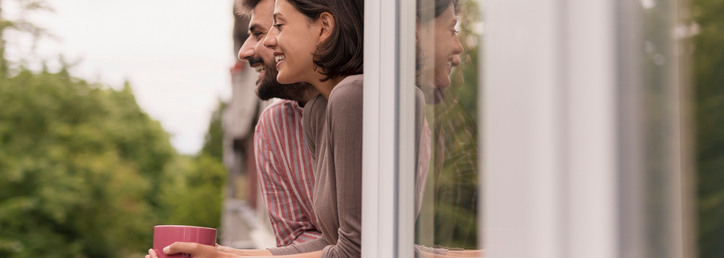 people looking out apartment window